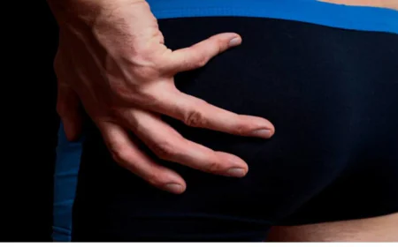 How can men reduce butt size through surgery?