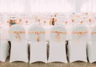 How Can Event Planners Use Floral Table Covers and Red Velvet Drapes to Elevate Wedding Décor?