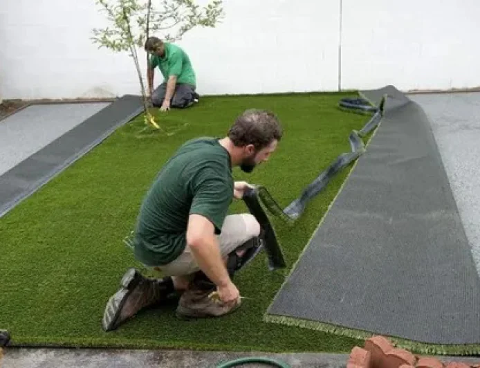 Artificial Grass and Stone Pathway Installation for Beautiful Outdoor Living Spaces